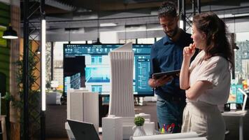 Diverse real estate team creating the layout for a residential area, simulating site preparation with 3D models before the project approval. Modern infrastructure city planning. Camera A. video