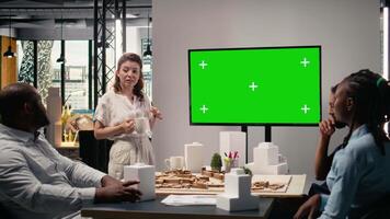 Real estate developers use green screen and architectural blueprints to collaborate in a smart city innovation hub, planning residential project with infrastructure and investment goals. Camera A. video