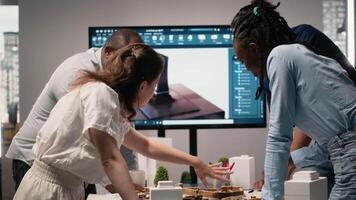 Close up of developers creating the layout for a residential project, simulating site preparation with 3D models before the construction. City planning and modern redevelopment. Camera B. video