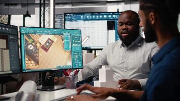 Engineer and designer working together on real estate interior design, using software for professional layout and structure. Creating master plans and reviewing construction blueprints. Camera A. video