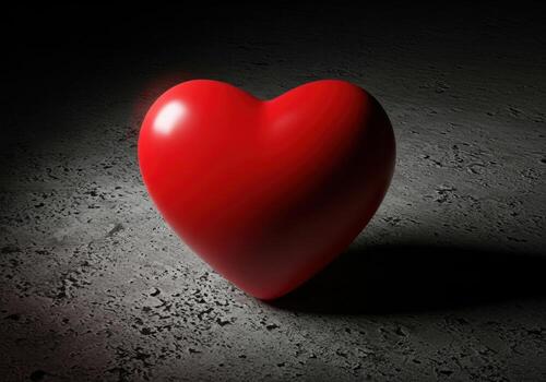 Crimson heart symbol of love and passion illuminated on a textured surface with dramatic shadow play photo