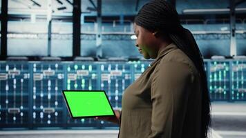 administrateur dans Les données centre en utilisant vert écran tablette à déployer Nouveau serveur architecture. serveur centre ouvrier en utilisant chrominance clé dispositif à faire sortir de la cyber-sécurité cadre, protéger données, caméra une video