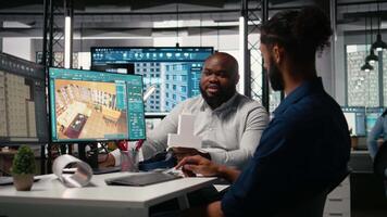Diverse property developers managing construction floor plan and layout design on a software, urban real estate development. Analyzing building blueprints for housing project. Camera A. video