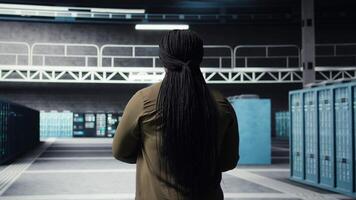 Data center software developer using deep learning tech to optimize operations. Server hub worker oversees specialized equipment accelerating complex artificial intelligence calculations, camera A video