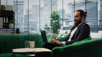 Business director using a modern holographic illustration of financial data, working with futuristic technology and holography animation to solve daily tasks in his luxurious office. Camera A. video