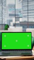 Vertical Empty global corporation office showcasing a green screen on laptop, modern workspace equipped with professional gadgets and networking system. Career development and motivation. video