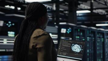 Programmer doing data center automation using AI software tools, enhancing workflow. Server room IT expert implements artificial intelligence driven predictive maintenance systems, camera B video