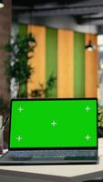 Vertical Green screen laptop in empty modern business workspace, human resources department office space prepared for hiring process, interviews and career development. Chroma key display on pc. video