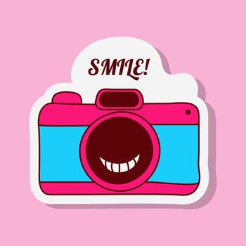 A colourful cartoon camera sticker is displayed. The camera has a smiley face on its lens and the text SMILE appears above. It is set against a light pink backdrop. vector