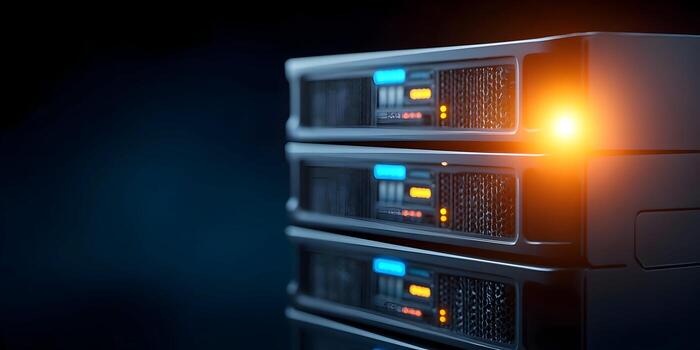A stack of modern server racks with glowing blue and orange lights operates in a dark data center environment photo