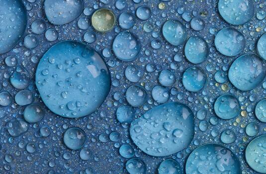 A close-up view of many glistening water droplets of a deep azure hue on a surface dotted with tiny gold specks, creating a captivating visual texture. photo