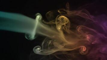färgrik strömmande rök lockar och driver mot en mörk bakgrund, skapande abstrakt former och mönster video