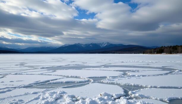 a frozen lake stretches beneath clouds, snow evenly spread, creating quiet patterns across the ice. photo