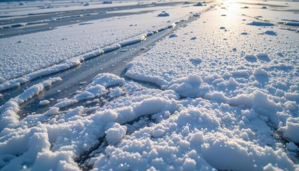 snow settles gently across frozen lake, delicate patterns forming, soft reflections of sunlight visible on ice. photo