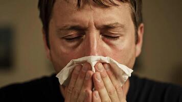 Mann weht seine Nase mit ein Gewebe während haben saisonal Allergien im das Herbst Jahreszeit video