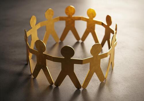 Interconnected golden paper figures forming a circle, symbolizing community and cooperation photo