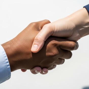 Diverse hands clasping in a firm handshake symbolizing partnership and agreement photo
