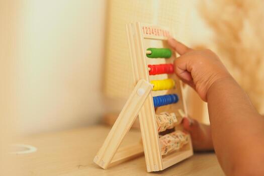 Child learns numbers with colorful counting frame in home photo