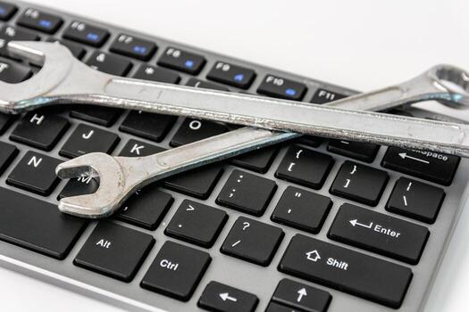 Computer keyboard with wrenchs for computer technical support maintenance concept. photo