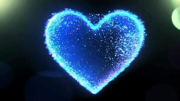 lysande blå hjärta form med gnistrande partikel effekt på en mörk bakgrund video
