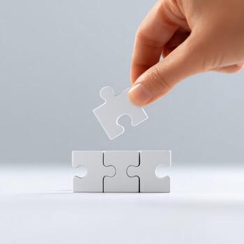 Focused hand placing final puzzle piece for completion. business concept showing connection, solution, and strategy. last step represents success and problem solving photo