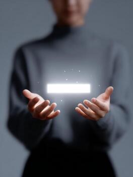 Focused person holding glowing digital object. light from future technology interface illuminates their hand, presenting modern innovation concept with empty space photo