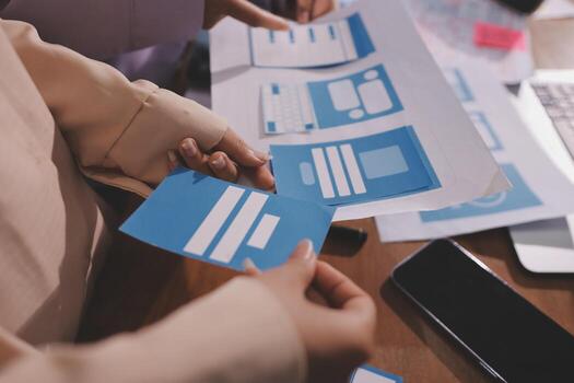 Hands holding blue interface design cards photo