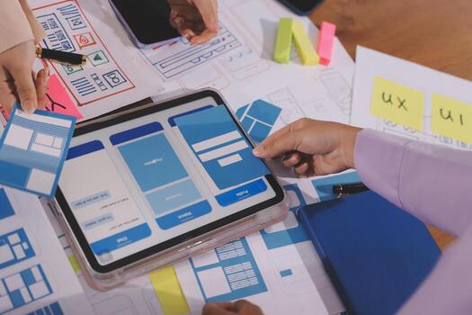 Team discusses UI design on a tablet photo