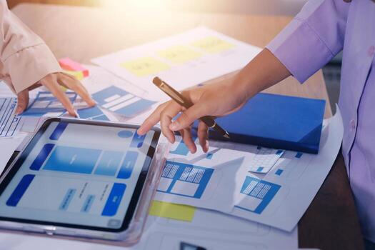 Hands working on tablet with design notes photo