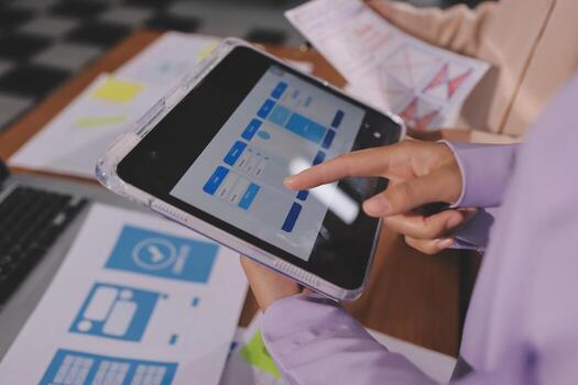 Person using tablet for UI design photo
