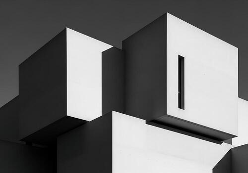 Monochromatic Abstract Geometric Architecture Modern Building Facade with Bold Shapes and Contrasting Light and Shadow photo
