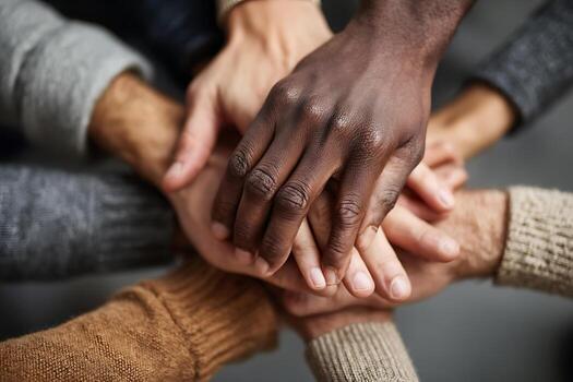 Diverse Hands Stacked in Unity, Symbolizing Teamwork and Collaboration photo