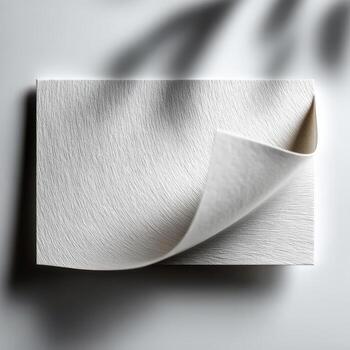 Textured white paper sample with curled corner photo
