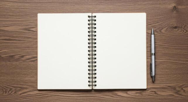 Blank spiral notebook and pen on wooden surface ready for ideas and notes photo