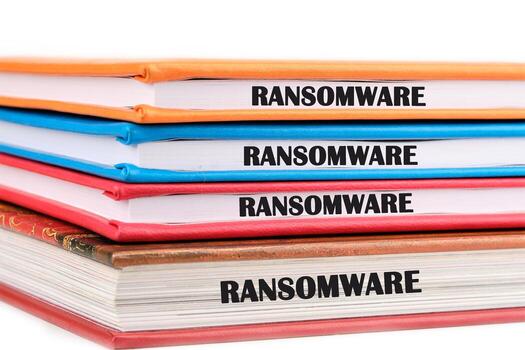 Colored binders labeled with ransomware provide a visual representation of cybersecurity topics in an office environment, emphasizing the importance of digital security awareness photo