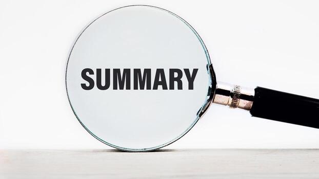 Conceptual summary word symbol. Copy space. Summary word written through a magnifying glass close-up photo