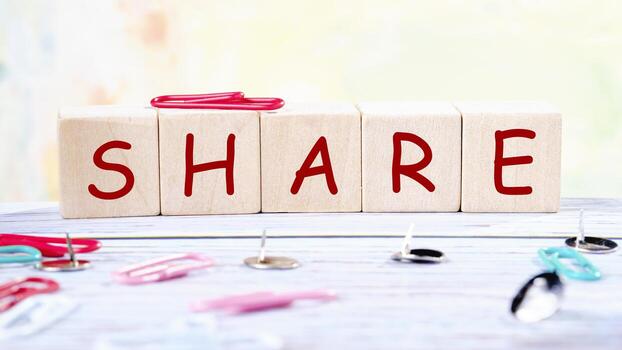 The concept word SHARE is collected of wooden cubes on an abstract background. Technology, website concept photo