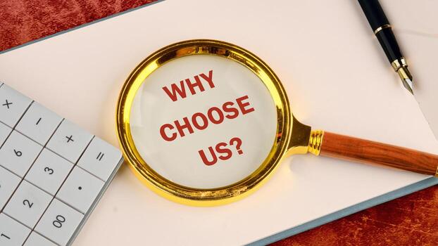 Why choose us. Market research, survey, business plan and report concept. Text WHY CHOOSE US on a blank page of a business notebook through a magnifying glass photo