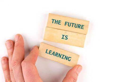 Concept of Intelligence, science and mind. THE FUTURE IS LEARNING made from blocks by hand on a light background, top view photo