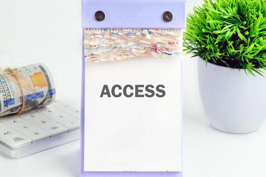 ACCESS text written on a desktop calendar on a white background. Business and accessible concept. Copy space photo