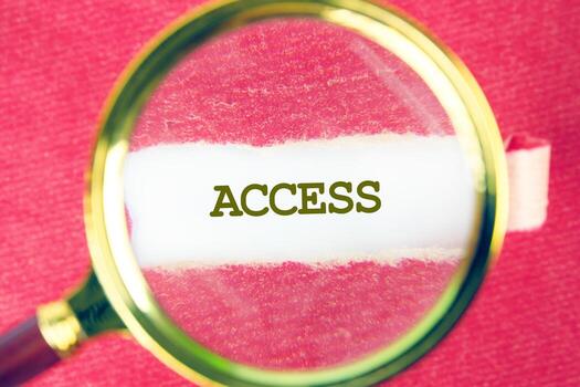 ACCESS word was found using a magnifying glass under a piece of paper. Cybersecurity security and encryption concept photo