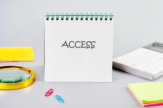 ACCESS word written in a notebook in a composition with a calculator, a magnifying glass, and stickers. Cybersecurity security and encryption concept photo