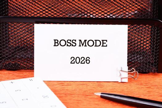 A card displaying the phrase BOSS MODE 2026 is clipped on a mesh organizer, symbolizing determination and focus on future business strategies for success photo