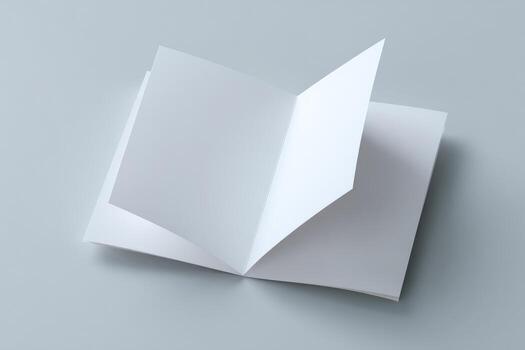 An open white book on a gray background photo