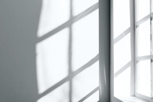 A white window with a shadow on the wall photo