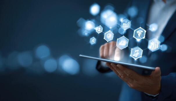 Businessman using tablet with icons on screen photo