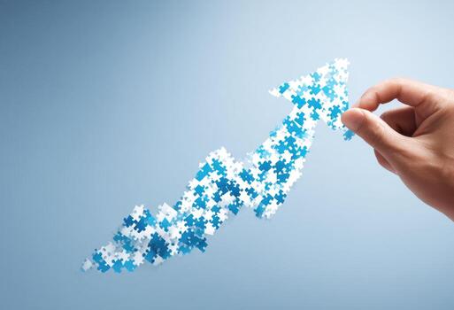 Hand holding puzzle pieces to form an arrow photo