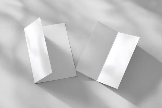 Two folded white paper on a gray surface photo