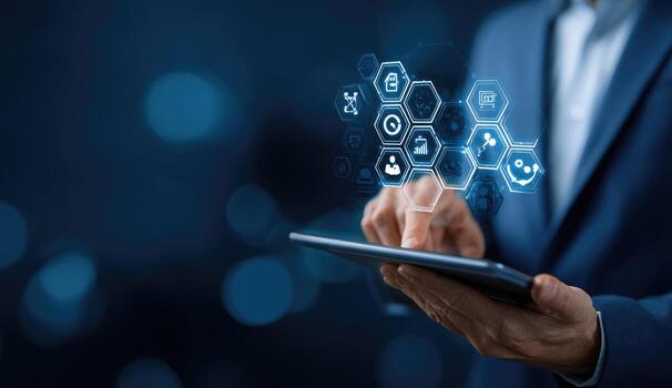 Businessman using tablet with icons on background photo