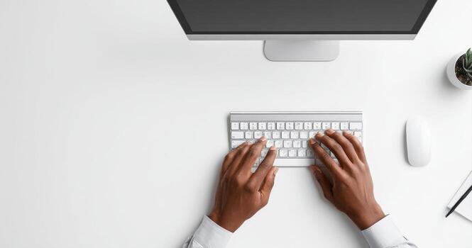 Hands typing on a keyboard and computer photo